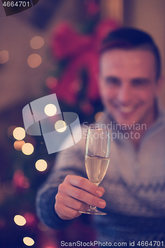 Image of young man with champagne glass  on party