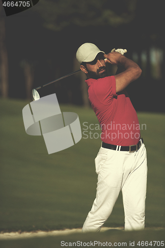 Image of golfer hitting a sand bunker shot