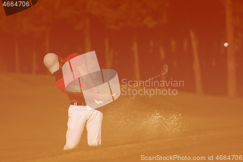 Image of golfer hitting a sand bunker shot