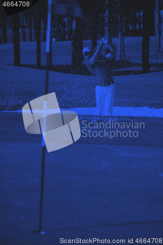 Image of golfer hitting a sand bunker shot