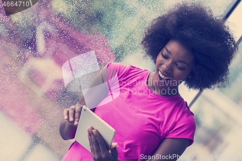 Image of african american woman using tablet
