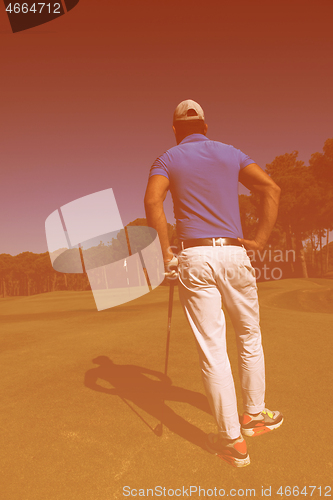 Image of golf player portrait from back