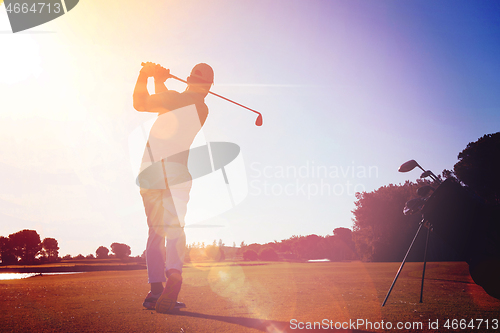 Image of golf player hitting shot with club