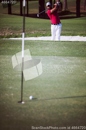 Image of golfer hitting a sand bunker shot