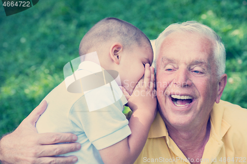 Image of grandfather and child have fun  in park