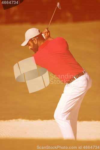 Image of golfer hitting a sand bunker shot