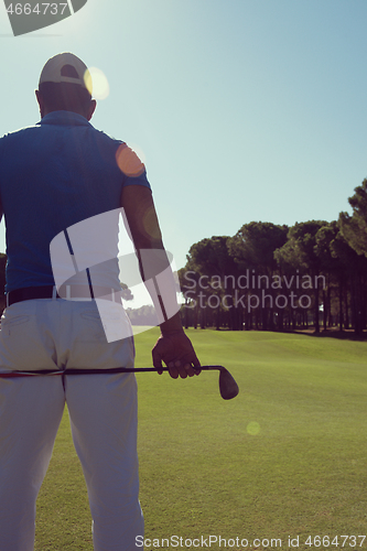 Image of golf player portrait from back