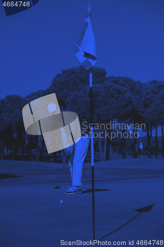 Image of golf player hitting shot at sunny day