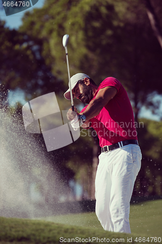 Image of golfer hitting a sand bunker shot