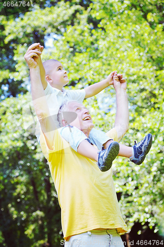 Image of happy grandfather and child in park