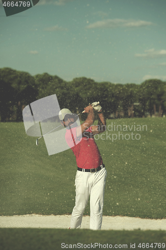 Image of golfer hitting a sand bunker shot