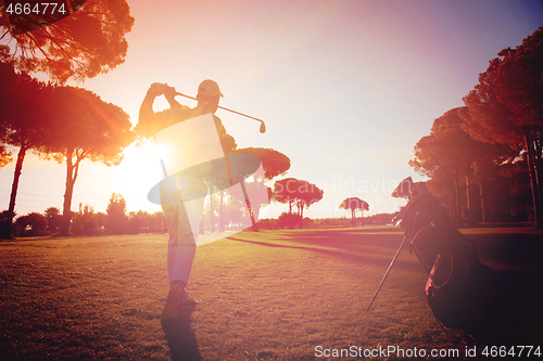 Image of golf player hitting shot with club