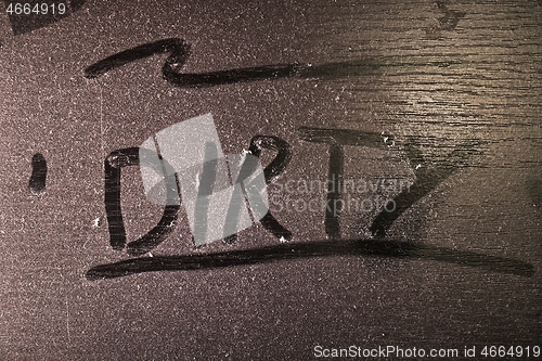 Image of Dust on a table surface with inscription