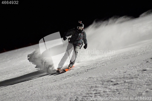 Image of Skiing in the winter snowy slopes at night