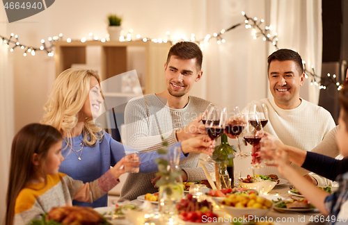 Image of happy family having dinner party at home