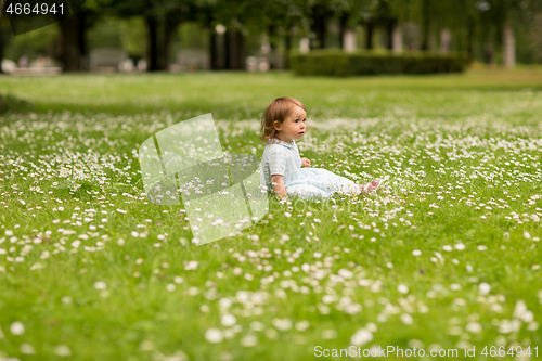 Image of happy little baby girl at park in summer