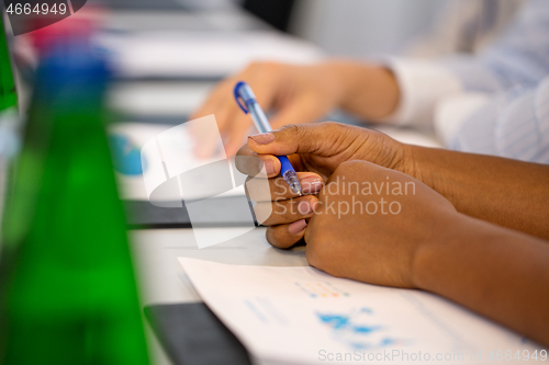 Image of hands of businesswoman at business conference