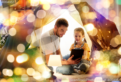 Image of family with tablet pc in kids tent at home