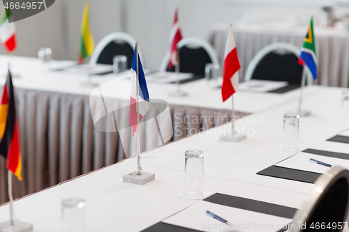 Image of table in boardroom at international conference