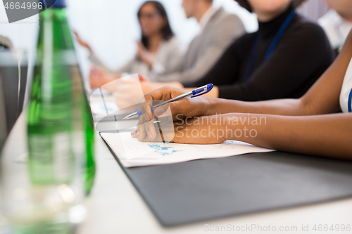 Image of hands of businesswoman at business conference