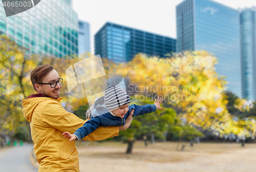 Image of father with son having fun in autumn tokyo city