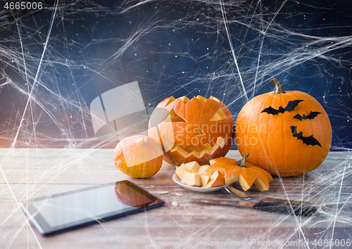 Image of halloween jack-o-lantern, pumpkins and tablet pc