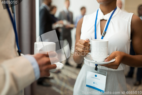 Image of business people with conference badges and coffee