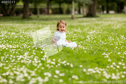 Image of happy little baby girl at park in summer