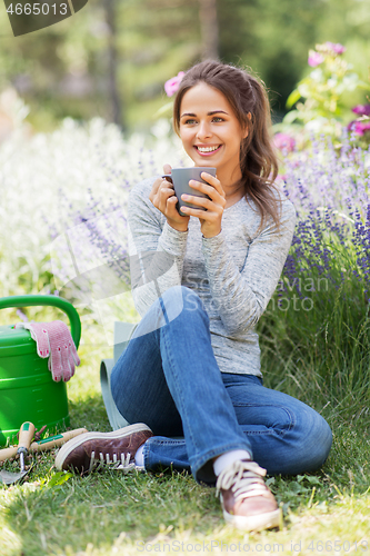 Image of woman drinking tea or coffee at summer garden