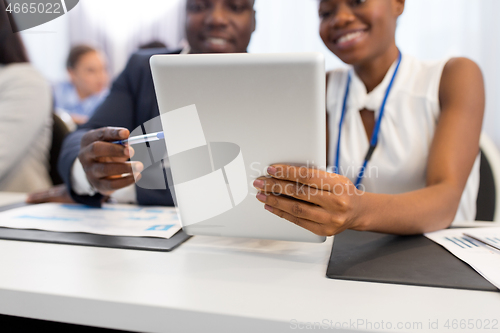 Image of people with tablet computer at business conference