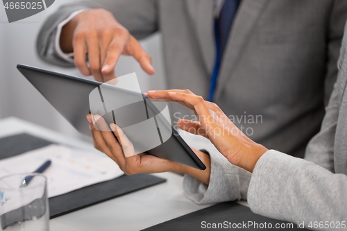 Image of people with tablet computer at business conference