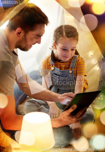 Image of family with tablet pc in kids tent at home