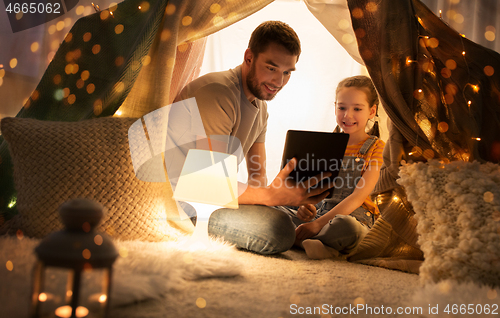 Image of family with tablet pc in kids tent at home