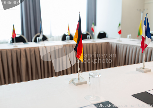 Image of flags at international conference boardroom