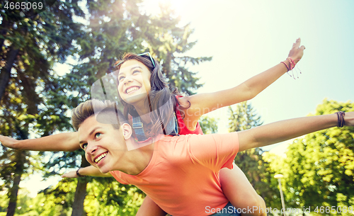 Image of happy teenage couple having fun at summer park