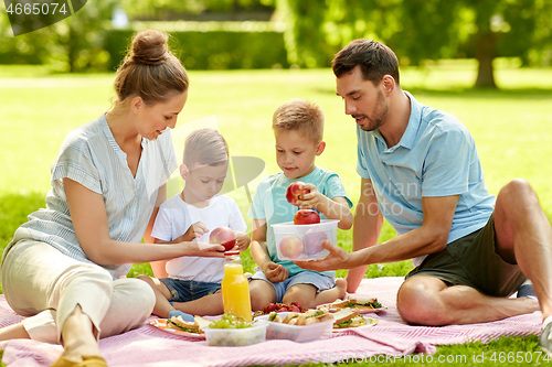 Image of happy family having picnic at summer park