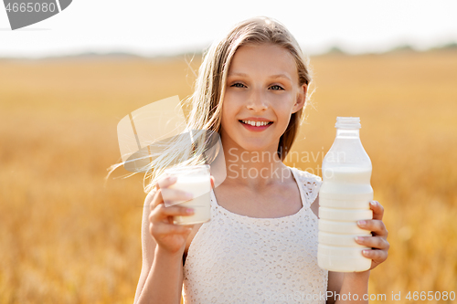 Image of girl with bottle and glass of milk on cereal field