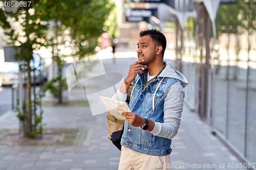 Image of indian man traveling with backpack and map in city