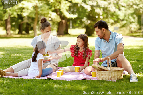 Image of happy family having picnic at summer park