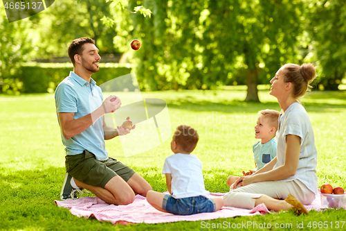 Image of happy family having picnic at summer park