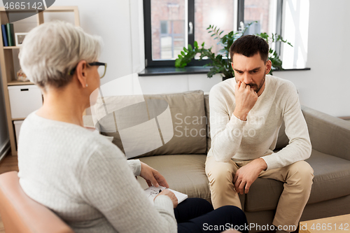 Image of senior woman psychologist and sad man patient