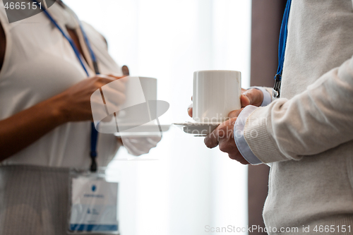 Image of business people with conference badges and coffee