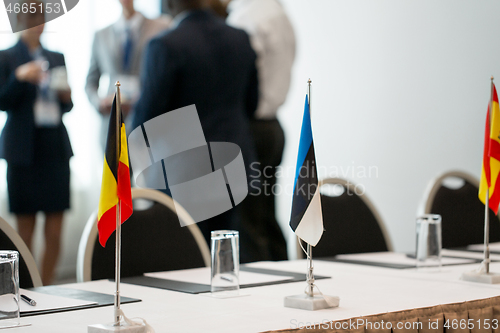 Image of table in boardroom at international conference