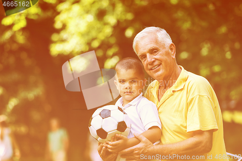 Image of grandfather and child have fun  in park