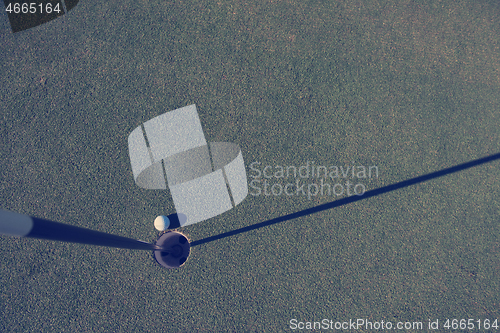 Image of top view of golf ball in the hole