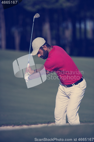 Image of golfer hitting a sand bunker shot