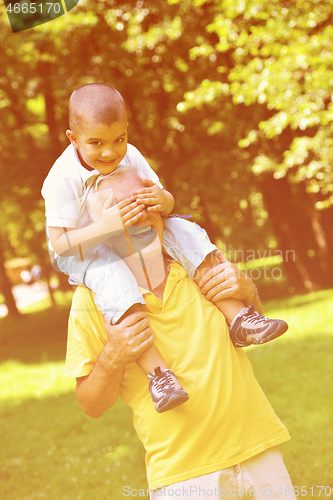 Image of happy grandfather and child in park