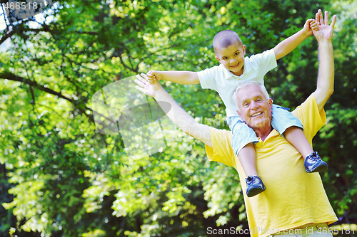 Image of happy grandfather and child in park