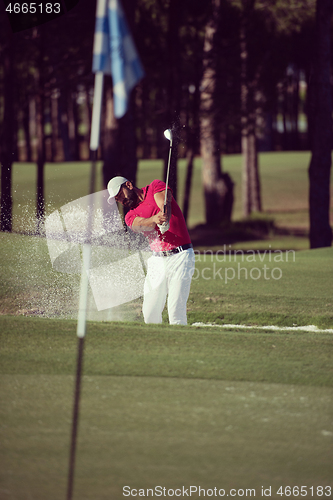 Image of golfer hitting a sand bunker shot