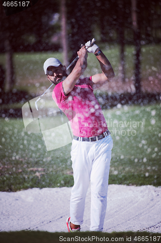 Image of golfer hitting a sand bunker shot